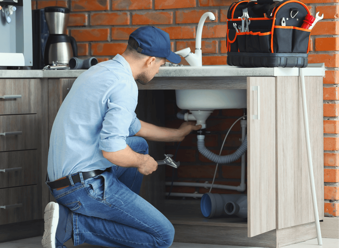 Plumbing Pilots LLC licensed plumber servicing a water heater in a Portage, IN home